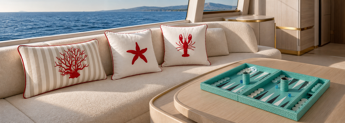 Veyra Deck embroidered outdoor cushions and a turquoise woven leather backgammon set in a yacht salon