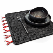Black cord placemat with red coral trim along the edge
