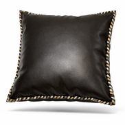 Black leather cushion with hand-braided cord in black, cream and ochre along its edge