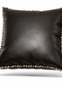 Black leather cushion with hand-braided cord in black, cream and ochre along its edge