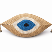 The beige evil eye cushion showing its crocheted texture and corner tassels
