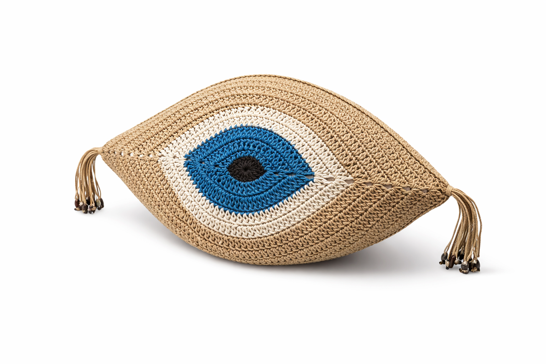 Beige crochet eye cushion from above, blue iris ringed in white