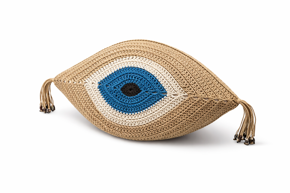 Beige crochet eye cushion from above, blue iris ringed in white