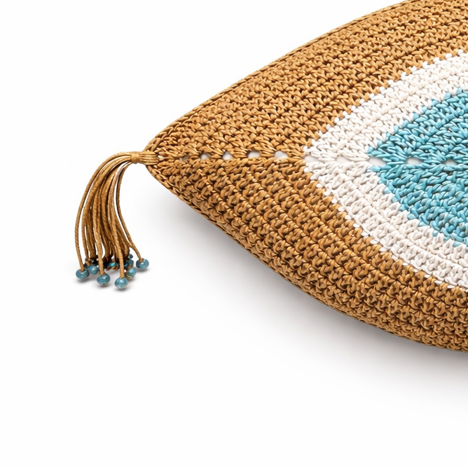 Camel crochet eye cushion from the side, tassels falling from each corner
