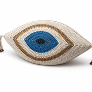 The cream and gold evil eye cushion, beaded tassels at the corners