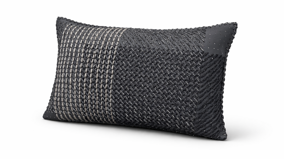 The anthracite hand-laced cushion showing its woven yarn texture