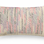 The ecru hand-laced cushion at an angle, diagonal rows of stitching