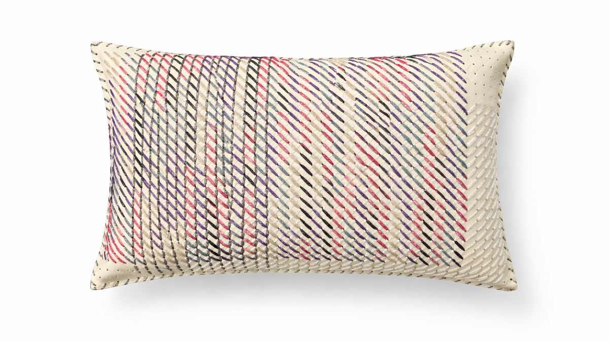 The ecru hand-laced cushion at an angle, diagonal rows of stitching