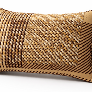 The natural tones cushion at an angle, whipstitched border in dark brown