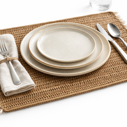 The jute shell placemat at an angle, dense hand-crocheted weave