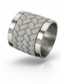 Woven leather and stainless steel napkin ring seen at an angle