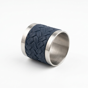 The navy napkin ring resting on its side, braid wrapped around the steel core