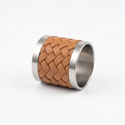 The tan napkin ring resting on its side, warm leather tone